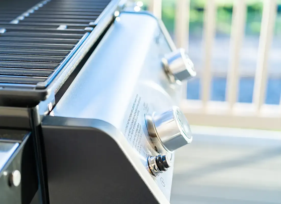 Nahaufnahme eines Gasgrills mit silbernen Drehreglern